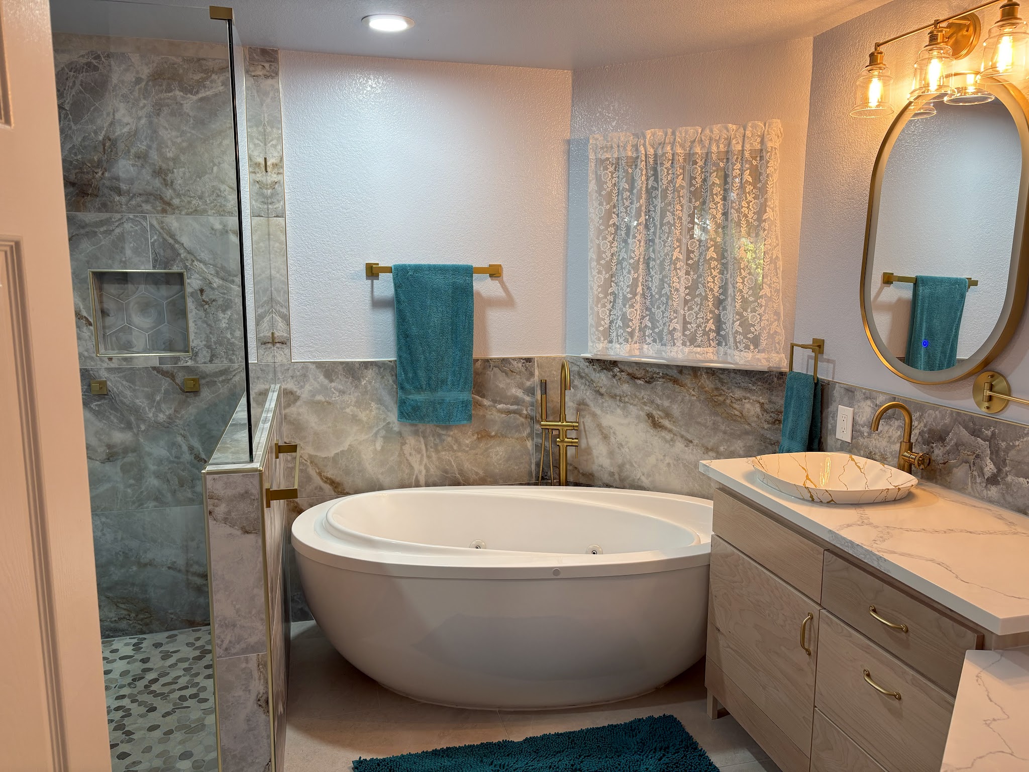 Finished master en-suite bathroom with soaking tub and marble tile