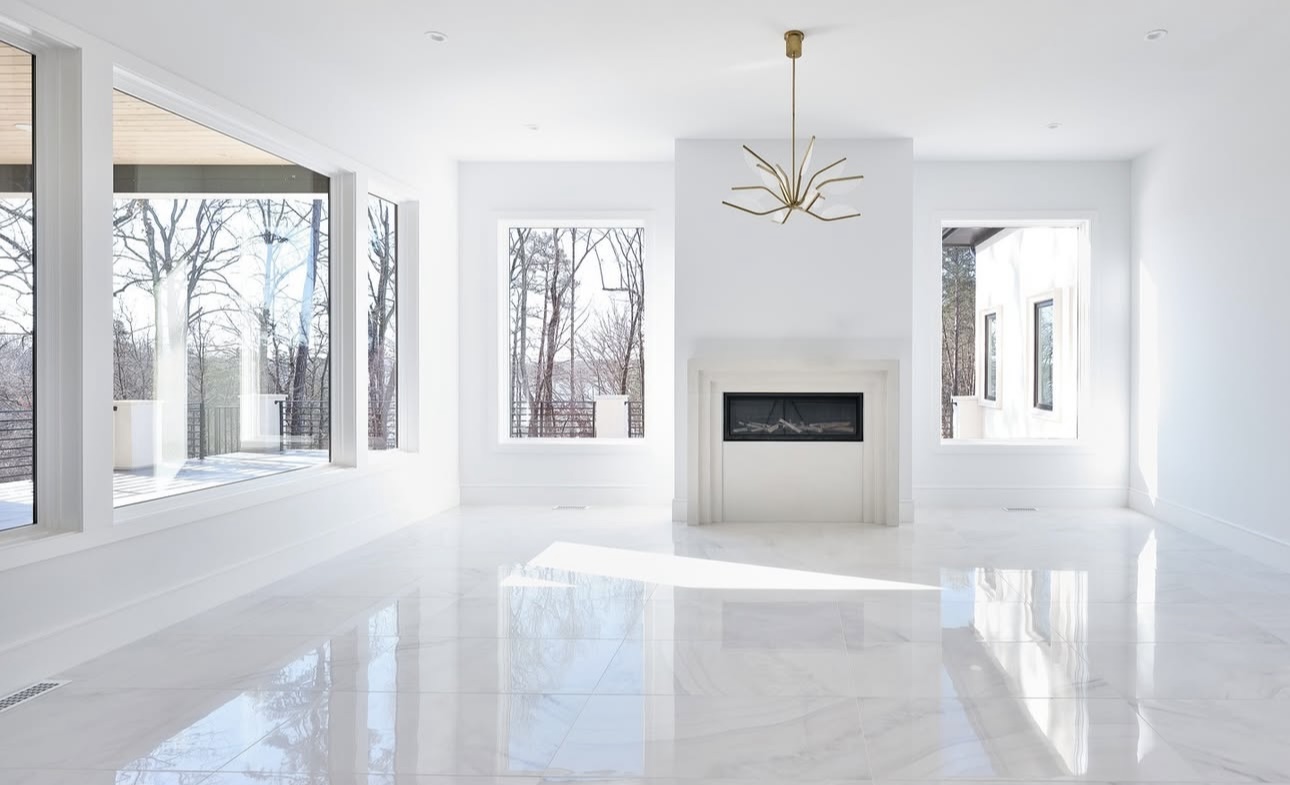 Bright living room with fireplace and marble tile floor