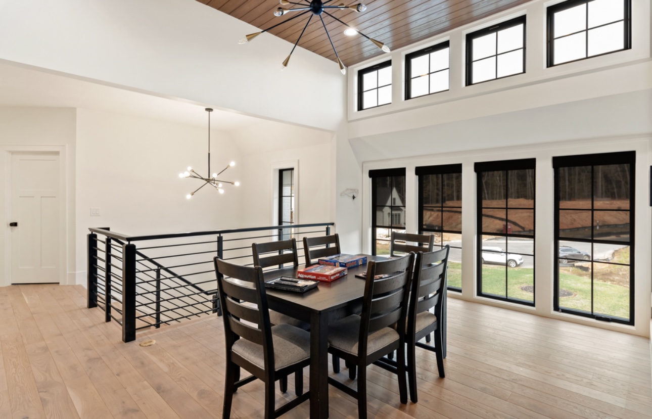 Open-concept dining nook with wood ceiling accent